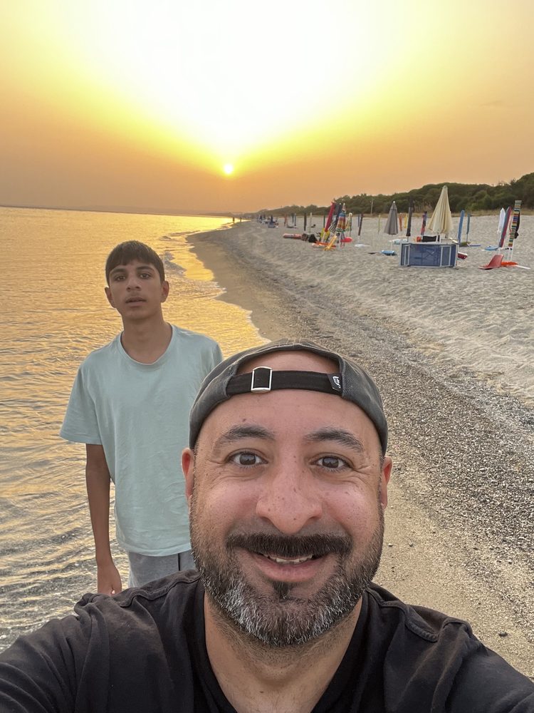 Sunrise selfie of Sonny and his eldest son on the beach at Sellia Marina